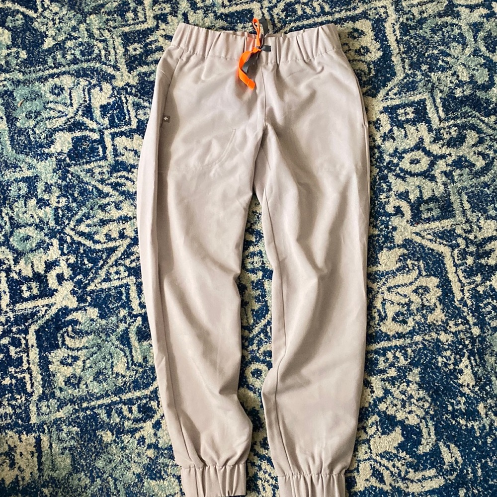 Taupe colored or pale gray fig uniform pants.